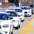 Sixty-three law enforcement vehicles from agencies around Northwest Arkansas participate in a “blue ...