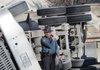 A trooper examines an overturned gravel truck Wednesday.