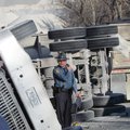 A trooper examines an overturned gravel truck Wednesday.