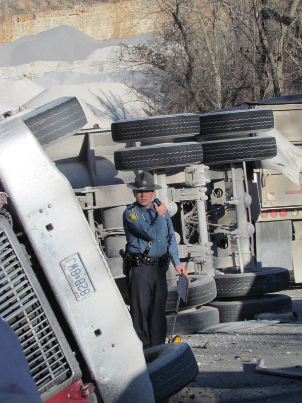 A trooper examines an overturned ...