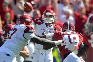 Kansas State quarterback Collin Klein and Arkansas quarterback Tyler Wilson (above) do things in different ways, but both have steered two major conference schools to 10-2 records and a ranking in the Bowl Championship Series top 10. They will go head-to-head Friday in the Cotton Bowl. 