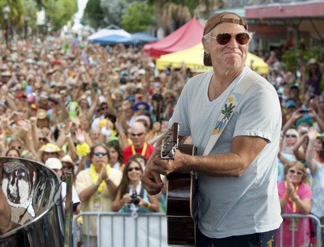 in-this-friday-nov-4-2011-photo-provided-by-the-florida-keys-news-bureau-singersongwriter-jimmy-buffett-performs-before-some-3500-of-his-fans-on-duval-street-in-key-west-fla-attendees-at-the-20th-parrot-heads-convention-were-surprised-when-buffett-made-a-rare-appearance-playing-with-his-coral-reefer-band-for-more-than-an-hour