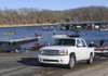 A crowd at the Prairie Creek ramp on Sunday is testimony to the tradition of fishing on New Year’s Day at Beaver Lake. Anglers in the Polar Bear bass tournament held Sunday take their boats from the water before weighing their fish.