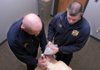 Capt. Jack Wassman, left, works with medic Cheyne Dake on Wednesday at the Rogers Fire Department’s Training Center on West Oak Street during an exercise with a dummy to practice using a bag-mask ventilation device.