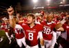 “Who doesn’t want to play on a top-10 stage with something to prove?” Arkansas quarterback Tyler Wilson asked. Wilson is seen here with his teammates singing the fight song.
