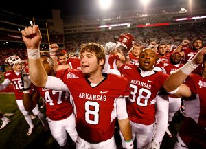“Who doesn’t want to play on a top-10 stage with something to prove?” Arkansas quarterback Tyler Wilson asked. Wilson is seen here with his teammates singing the fight song.