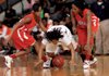 Jacksonville’s Shakyla Hill (left), Jessica Jackson (right) and Little Rock Hall’s Jalisa Cole scramble for a loose ball during Thursday’s game in Little Rock. 
