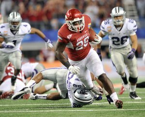 Rumbling man Arkansas running back Broderick Green (29) gets past Kansas State defender Tre Walker during the fourth quarter of Friday’s game in Arlington, Texas. Green finished with 64 yards on seven carries in Arkansas’ fourth Cotton Bowl victory. 