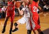 Sarah Smith, Fayetteville junior guard, attempts a shot from the block as Fort Smith Northside sophomore Brianna Jackson, left, and junior post Courtney Flemming defend Friday during the first half of play at Fayetteville High School.
