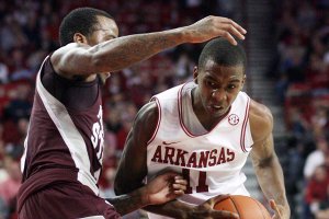 Arkansas' B.J. Young drives against Mississippi State's Dee Bost Saturday, January 7, 2011 at Bud Walton Arena in Fayetteville.