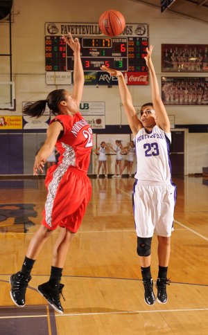 Vanessa Matlock, Fayetteville senior post, takes a shot over Fort Smith Northside junior forward Kilah Cummings, left, on Friday during the first half of play at Fayetteville High.

