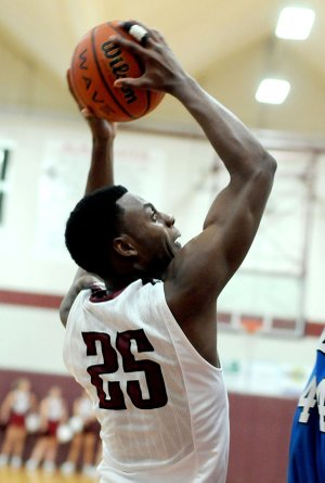 D.J. Evans, Springdale High sophomore, shoots against Rogers on Friday in the first half at Bulldog Gym in Springdale.

