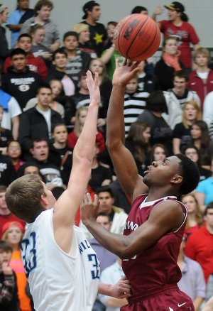 Alex Rice, left, of Springdale Har-Ber tries to block Springdale High’s D.J. Evans as he takes a shot Tuesday at Wildcat Arena in Springdale.