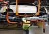 Jeff Danes moves a battery charger for a Ford Focus on the assembly line at the Ford Michigan Assembly plant in Wayne, Mich., in December. The auto industry gave the economy a boost in the final weeks of 2011, the Federal Reserve said Wednesday. 