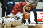 Arkansas guard B.J. Young and Mississippi’s Reginald Buckner go for a loose ball on Wednesday in Oxford, Miss.