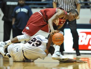 Arkansas guard B.J. Young and Mississippi’s Reginald Buckner go for a loose ball on Wednesday in Oxford, Miss.