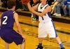 Keifer Holt, Rogers guard, right, passes around Fayetteville’s Cameron Paschke in King Arena on Tuesday.
