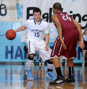 Springdale Har-Ber’s Jacob Berry, left, looks for a route around Springdale High’s Chasen Williamson on Tuesday in Wildcat Arena. Berry and the Wildcats will host Rogers High tonight in a 7A-West Conference game.
