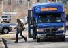 A passenger disembarks an Ozarks Regional Transit bus Thursday on West Dickson Street while it makes its way on ORT’s Route 40. The route has stops at Hillcrest Towers, the Veterans Health Care System of the Ozarks, Fiesta Square, the Northwest Arkansas Mall, the Springdale Walmart Supercenter, Foxfire and Spring Meadows apartments and Ozark Guidance Center.
