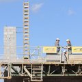 Construction workers from Fayetteville Mechanical and Walker Masonry work simultaneously building a ...