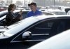 Tevian Rose, left, shops for a used car Wednesday with Andrew Williams, a salesman at Landers McLarty in Bentonville. Sales of used vehicles seem to be turning around as prices and availability stabilize and the economy improves.
