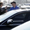 Tevian Rose, left, shops for a used car Wednesday with Andrew Williams, a salesman at Landers McLart...