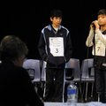 31 ROUNDS OF WORDS Safi Haider, 11, left, representing Bentonville’s Spring Hill Middle School, watc...