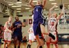 Fayetteville’s Aubrey Edie, center, takes the ball to the basket in front of Rogers Heritage’s Raya Jones during their game Friday in Rogers.
