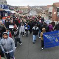 A crowd of around 300 people march west up Dickson St. Monday Jan. 17, 2011 in honor of Martin Luthe...