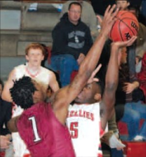 Springdale’s Jarvis Odems blocks the shot by Northside’s Shaquille Jones on Friday at Northside.
