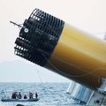 Italian firefighters' scuba divers approach the luxury cruise ship Costa Concordia which ran aground...