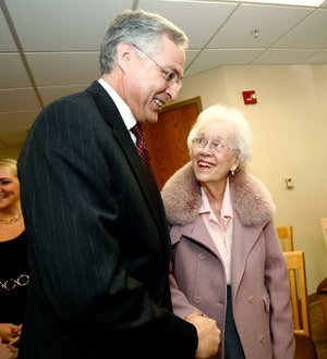 Chancellor Dan Rahn of the University of Arkansas for Medical Sciences speaks to Pat Walker of Springdale following a news conference Tuesday announcing a $1.5 million gift to the UAMS Northwest Campus in Fayetteville from the Willard and Pat Walker Charitable Foundation.
