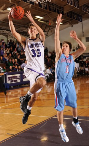 Caleb Waitsman, a Fayetteville junior forward, scores in transition ahead of Fort Smith Southside senior forward Samuel Ross on Tuesday at Fayetteville High.