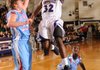 Manuale Watkins, a Fayetteville junior guard leaps to score in the lane past Fort Smith Southside senior post Jesse Young, left, and senior guard Dequan Collins on Tuesday during the Dogs’ 60-57 win at Fayetteville High. Watkins is in his first season with the Bulldogs after moving to Fayetteville from Columbia, Mo.
