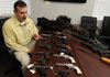 Lt. Cecil White, detective with the Springdale police department, talks about several guns recovered in a raid of a Rogers home Rogers Friday Jan. 20, 2012 at a press conference in the Springdale criminal investigation building in Springdale. Members of the Rogers police department recovered 15 handguns and four long guns that were stolen from Sturm's Indoor Gun Range in Springdale earlier in the week.