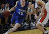 Josh Anderson, Rogers High, drives around a Rogers Heritage defender Friday in War Eagle Arena. Anderson was named 7A-West Conference Boys Player of the Week.
