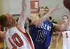 Sarah Grace Groves, Rogers High, tries to shoot around Heritage’s Raya Jones on Friday at Heritage High in Rogers.
