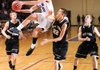 STAFF PHOTO ANDY SHUPE
Elkins' Spencer Jones (10) leaps to score as West Fork junior Trusten DeSoto (22) reaches to defend Friday, Jan. 13, 2012, at Elkins High School. Go to nwaonline.com/photoreprints to see more photos.