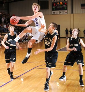 STAFF PHOTO ANDY SHUPE
Elkins' Spencer Jones (10) leaps to score as West Fork junior Trusten DeSoto (22) reaches to defend Friday, Jan. 13, 2012, at Elkins High School. Go to nwaonline.com/photoreprints to see more photos.