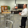 Mathews gives a tour of the test restaurant in the new training center Jan. 11 in Springdale.
