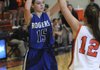 Sarah Grace Groves, Rogers High, tries to work the ball around Heritage’s Brittany Ward on Friday at Heritage High School in Rogers.
