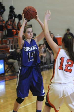 Sarah Grace Groves, Rogers High, tries to work the ball around Heritage’s Brittany Ward on Friday at Heritage High School in Rogers.
