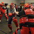 Amanda Grinter of Rogers kicks to get away from an attacker Thursday during the self-defense class h...