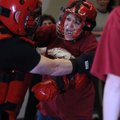 Lynette McClelland of Springdale fights to get away from an attacker Thursday during the self-defens...