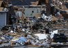 Residents walk around through the debris of their neighborhood after a possible tornado ripped through the Trussville, Ala. area in the early hours of Monday, Jan. 23, 2012. Jefferson County sheriff's spokesman Randy Christian said the storm produced a possible tornado that moved across northern Jefferson County around 3:30 a.m., causing damage in Oak Grove, Graysville, Fultondale, Center Point, Clay and Trussville. 