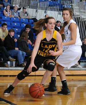 STAFF PHOTO SAMANTHA BAKER -- Prairie Grove's Whitnee Fitts, left, dribbles past Alexis Jones of Shiloh Christian on Tuesday, Jan. 24, 2012 in Springdale. 