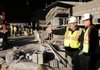 Ron Shelby, left, chief executive officer of Hight-Jackson Associates, the lead architecture firm for the Fayetteville High School construction project, tours the site with Ginny Wiseman, associate superintendent for administrative services for Fayetteville Public Schools, on Monday at the building site, located behind Fayetteville High School near Martin Luther King Jr. Boulevard.