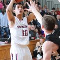 Jordan Dennis of Springdale High shoots over a Bentonville defender Tuesday as the Bulldogs took on ...