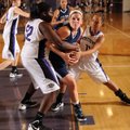 Caroline Eubanks, center, a Springdale Har-Ber senior post player, is tied up beneath the basket by ...