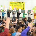 Asbell Elementary School students hold a series of signs Wednesday, Jan. 25, 2012, during an assembl...
